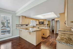 Kitchen featuring a center island, coved ceiling with skylight.