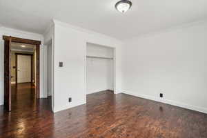 Main floor bedroom with two closets,  hardwood flooring