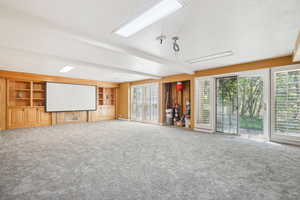 Theater room with oak shelves, plantation shutters, new carpet.  Place for gas fireplace