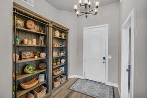 Interior space featuring hardwood / wood-style flooring and a chandelier