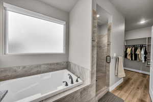 Bathroom featuring hardwood / wood-style flooring and independent shower and bath