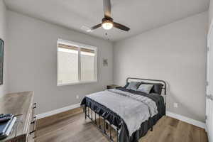 Bedroom featuring light hardwood / wood-style floors and ceiling fan