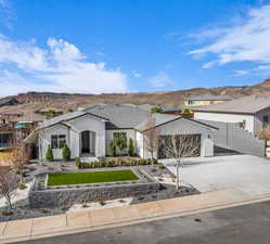 View of front of home with a mountain view and a garage