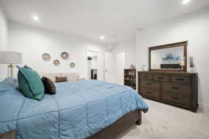 Bedroom featuring light carpet