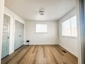 Interior space featuring light hardwood / wood-style flooring and a textured ceiling