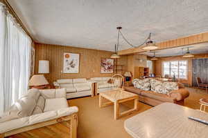 Carpeted living room with a textured ceiling