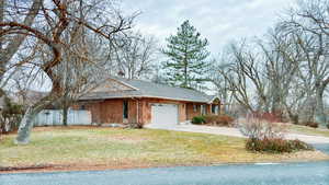 View of front of house featuring a garage and a front yard