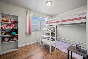 Bedroom featuring hardwood / wood-style flooring and a textured ceiling