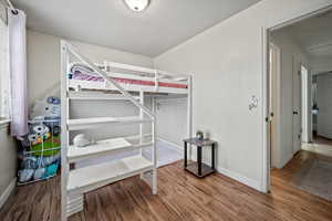 Bedroom with hardwood / wood-style floors