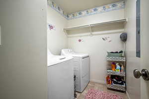 Washroom with washing machine and clothes dryer