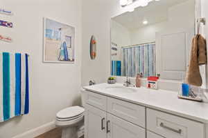 Bathroom with walk in shower, vanity, and toilet