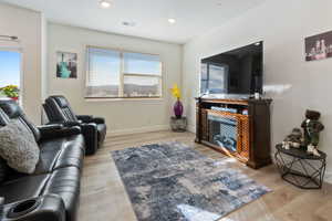 Living room with a healthy amount of sunlight and light wood-type flooring