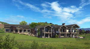 Rear view of property with a lawn and a deck