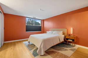 Bedroom featuring light hardwood / wood-style floors and a closet