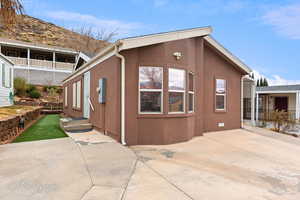 View of side of home featuring a patio area