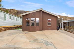 View of side of property with a mountain view