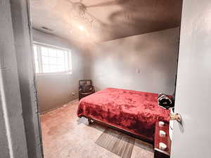 Bedroom featuring a textured ceiling and carpet