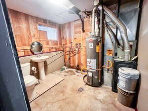 Utility room featuring sink and water heater