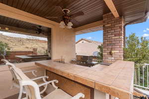 View of patio / terrace with area for grilling, an outdoor bar, and ceiling fan