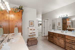 Bathroom with tile patterned floors and vanity