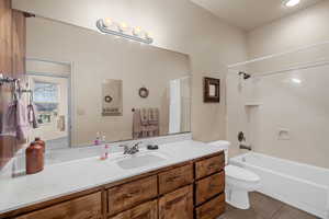 Full bathroom featuring vanity, tile patterned floors, toilet, and shower / bathtub combination with curtain