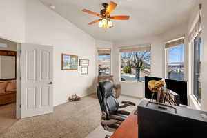 Office with vaulted ceiling, light carpet, and ceiling fan