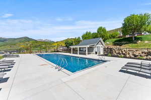 View of swimming pool featuring a mountain view and a patio