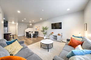 Living room with sink and light hardwood / wood-style floors