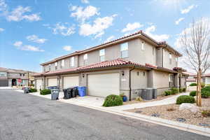 View of front of property with central AC unit and a garage