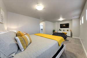 Bedroom featuring light carpet