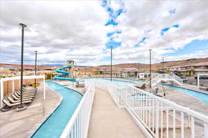 View of swimming pool with a mountain view, a patio, and a water slide