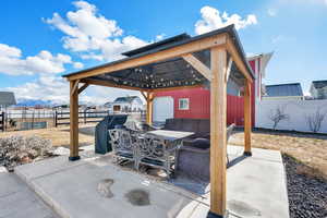 View of patio featuring a gazebo, a mountain view, and the barn.