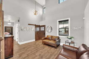 Front entry room with custom light, entry closet and hallway to half bath + laundry room.