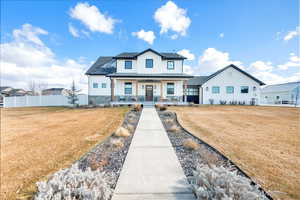 View of front of property featuring a porch and the front yard