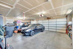 Interior of 3 car garage. The single car stall at the back has a built in workbench/storage area.