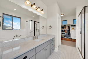 Bathroom with large vanity and an enclosed shower