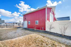 View of barn structure featuring a garage door on the side and a mountain view.