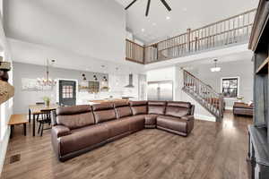 Living room featuring a high 2-story ceiling, views of the upstairs walkway and part of the entry room.