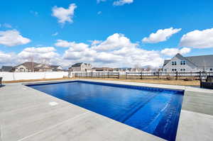 View of the heated 40x20 foot vinyl sport pool featuring a patio area.