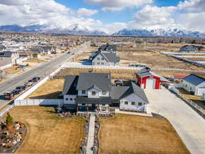 Birds eye view of the modern farmhouse style home with a mountain view via drone.