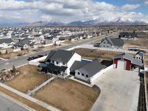 Modern farmhouse style home with a mountain view via drone.