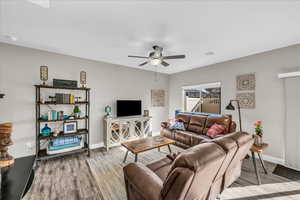 Living room featuring hardwood / wood-style flooring and ceiling fan