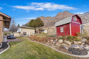 View of yard with a mountain view and a storage unit