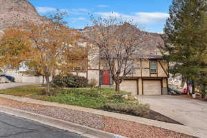 View of front of house featuring a mountain view and a garage