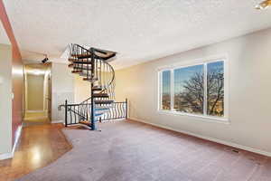 Interior space featuring hardwood / wood-style flooring and a textured ceiling