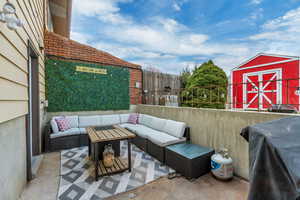 View of patio featuring grilling area, a storage unit, and outdoor lounge area