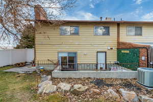 Rear view of property featuring a patio and central AC