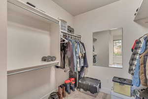 Walk in closet featuring carpet flooring