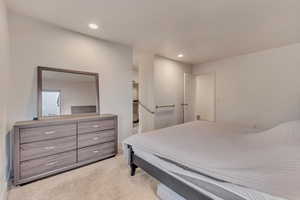 Bedroom featuring light colored carpet