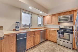 Kitchen with appliances with stainless steel finishes and sink